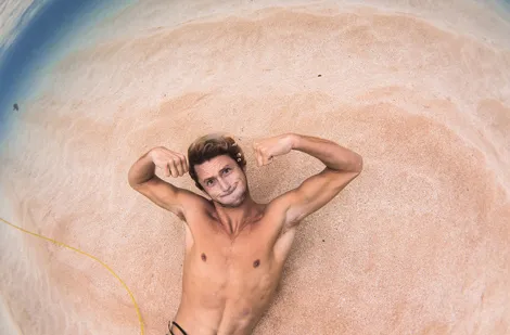 Crosby Colapinto laying on the sand underwater