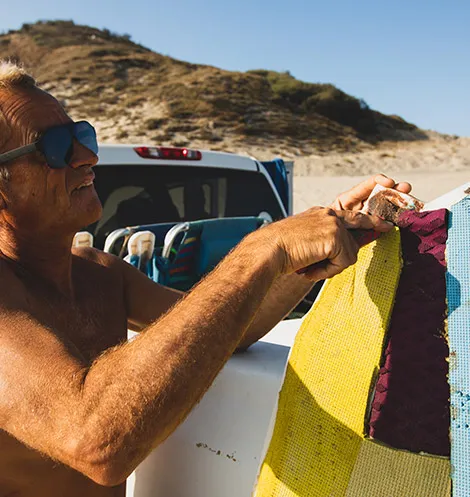 Tom Curren fixing a surfboard